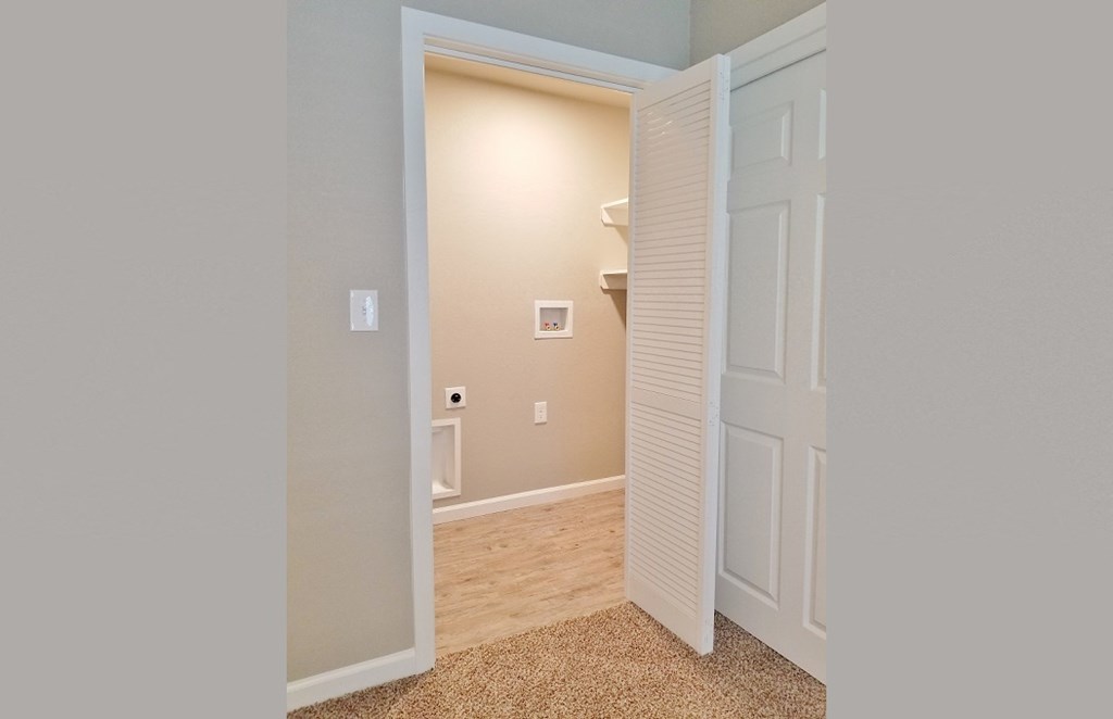 View into utility room with washer and dryer connections
