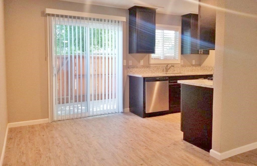 View of dining and kitchen area and sliding glass door leading to private patio