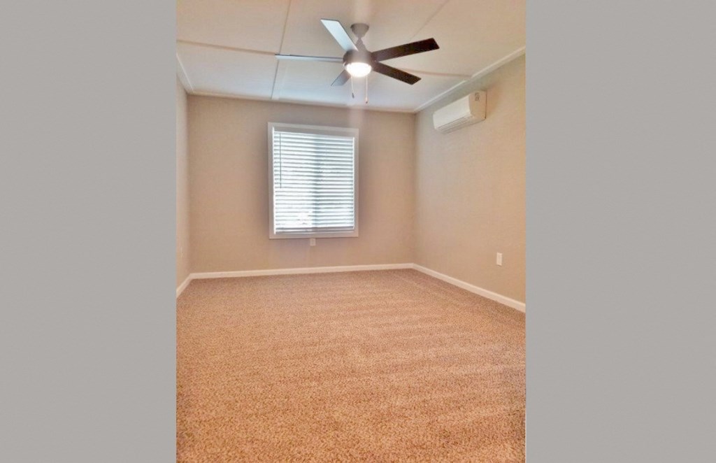 View of bedroom with well it window, ceiling fan, and AC