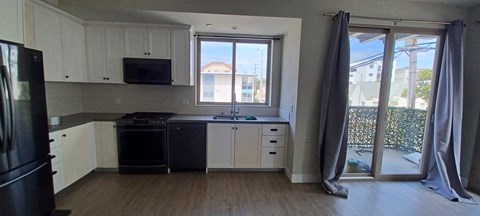 a kitchen with a stove and a window