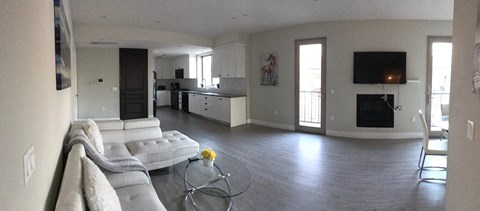a living room with a white couch and a glass table