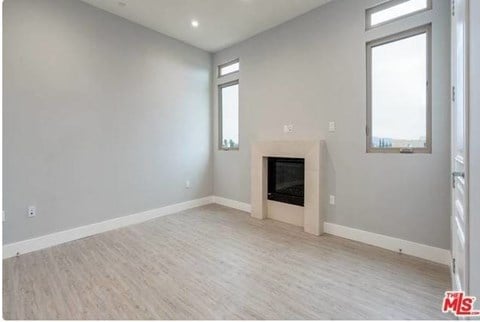 a living room with a fireplace and a wooden floor