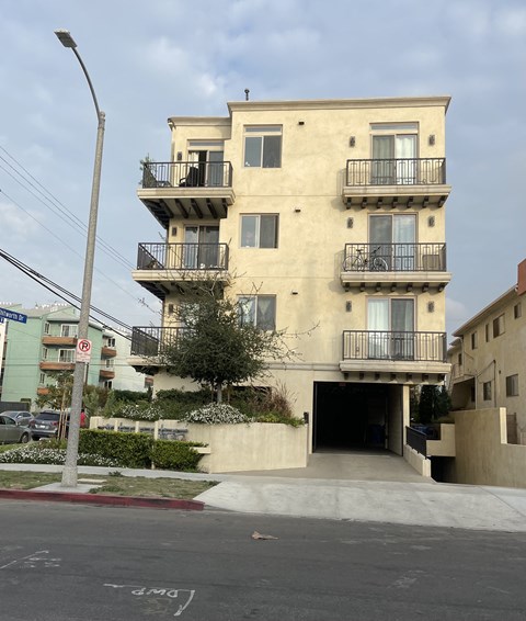 an apartment building on the corner of a city street