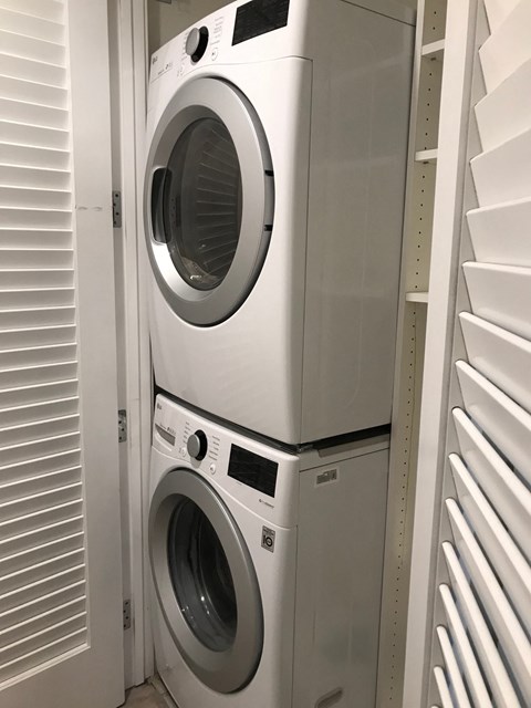 a front loading washer and dryer in a laundry room