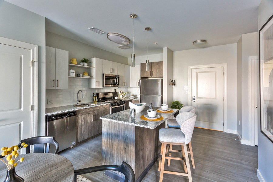 A modern kitchen with a dining table and chairs.