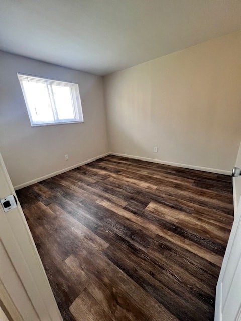 A room with wooden flooring and a window.