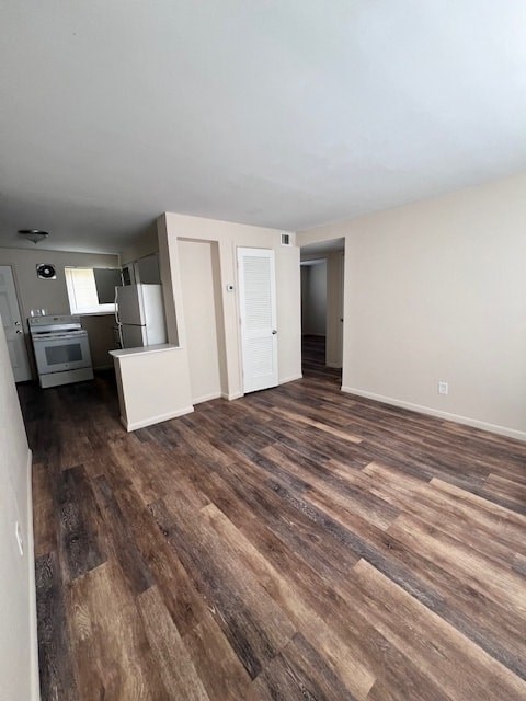 A room with wooden flooring and white walls.