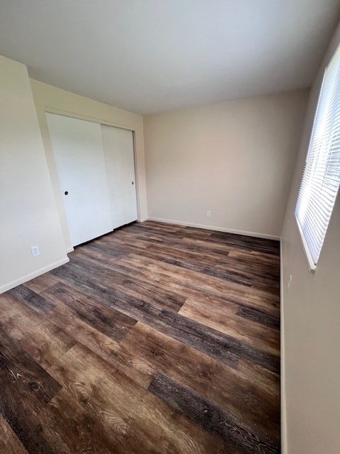 A room with a wooden floor and a white door.