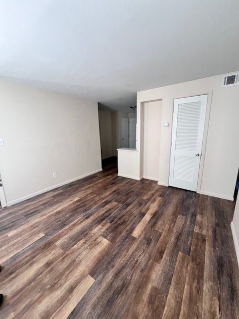 A room with wooden flooring and white walls.