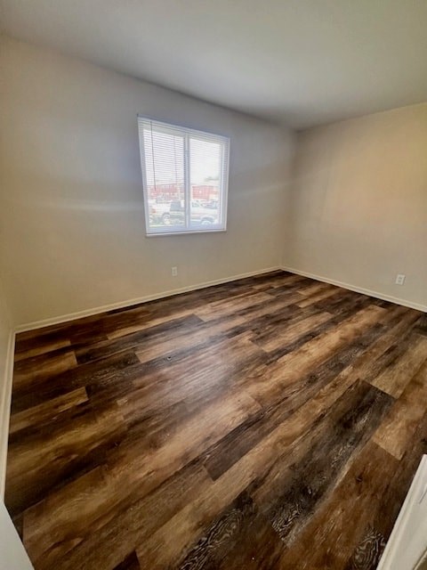 A room with wooden flooring and a window.