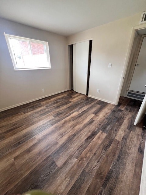 A room with wooden flooring and a window.