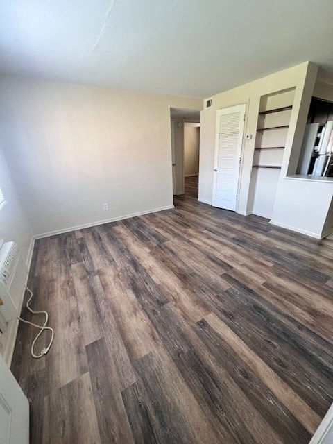 A room with wooden flooring and white walls.