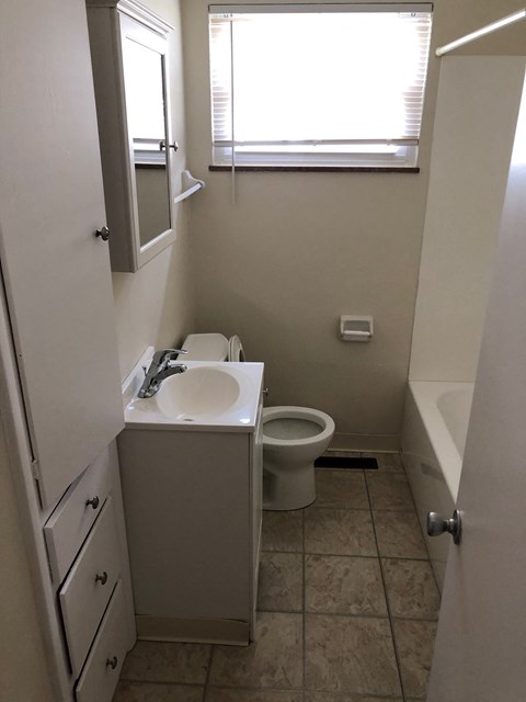 A white sink and toilet in a small bathroom.